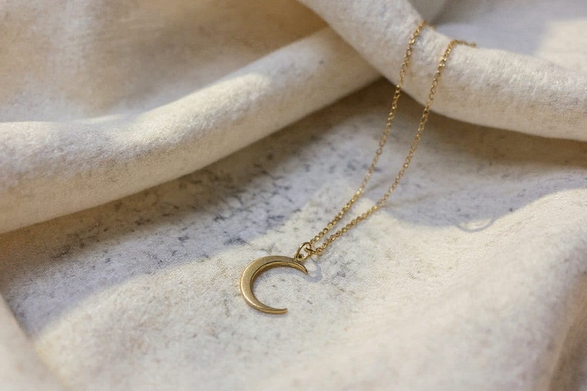 Lune & Co, Delicate piece styled on a soft neutral surface, jeweller's lighting, glinting detail
